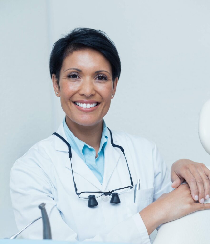 Smiling dentist in a clinic setting, confident due to reliable IT support ensuring smooth operations for her dental practice